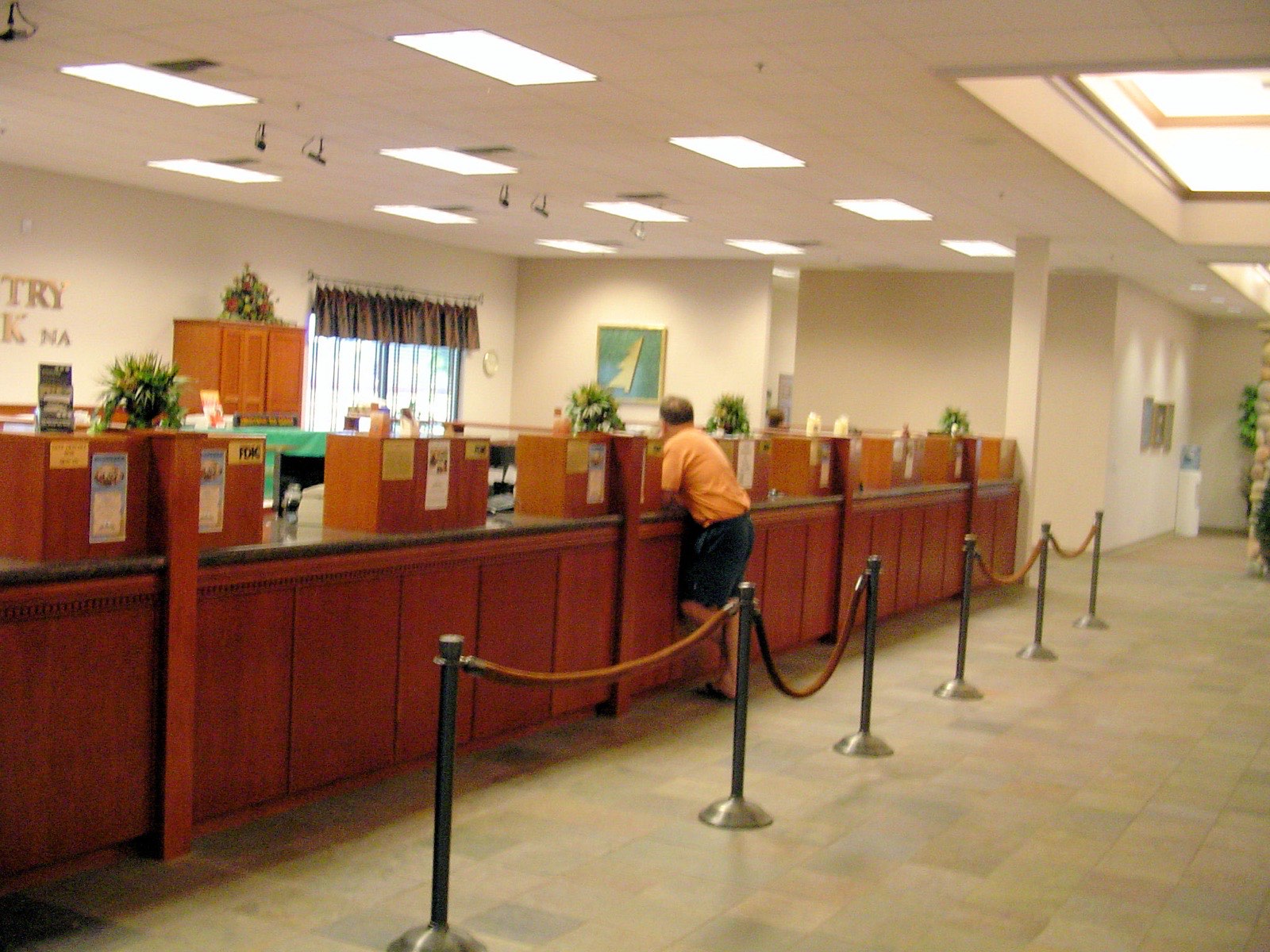 Custom wood teller counter and cabinetry built and installed inside a bank