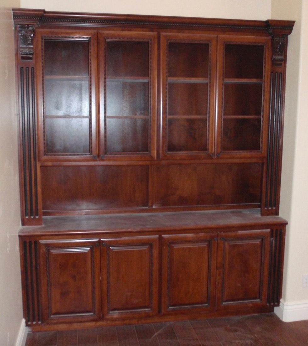Tall custom wood hutch with glass door cabinetry built by Caldwell Enterprise